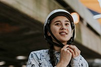 Woman removing white skate helmet