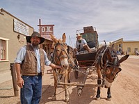 A mule-drawn stagecoach, its driver, and a handler near the famous O.K. Corral in Old Tombstone, now a tourist attraction in southeastern Arizona. Original image from <a href="https://www.rawpixel.com/search/carol%20m.%20highsmith?sort=curated&amp;page=1">Carol M. Highsmith</a>&rsquo;s America, Library of Congress collection. Digitally enhanced by rawpixel.