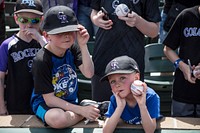 Young fans of the Colorado Rockies major-league baseball team wait and hope for player autographs at a Spring Training game between the Rockies and the Arizona Diamondbacks in Scottsdale, Arizona.