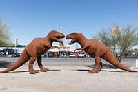 Two large, ferocious-looking Tyrannosaurus metal-art sculptures face off outside Holt&#39;s gas station and gift shop in Gila Bend, Arizona, a small city named for the Gila River, not the large, venomous gila monster lizard.
