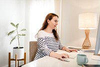 Woman using computer, working from home during the new normal