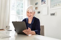 Senior successful businesswoman planning project on tablet, home office image