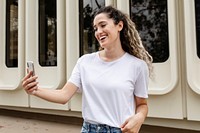 Woman in white tee, video calling on a phone, casual wear