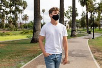 Man wearing face mask in park, the new normal lifestyle, summer time