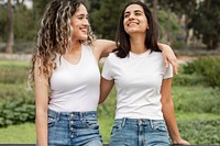 Women in casual wear apparel, talking in a park