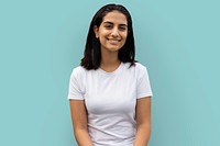 Hispanic cheerful woman in white tee portrait, blue background