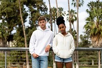 Couple in casual wear apparel, chilling in a park