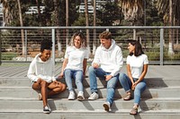 Diverse friends in casual streetwear, talking on steps