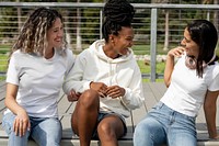 Diverse women in casual apparel, talking on steps