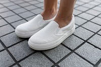 Plain white sneaker, women's footwear on a grey tiled floor