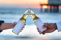 Blank beer bottle label, woman and man drinking by the beach