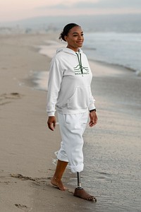 Casual disabled woman walking by the beach