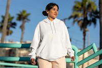 Woman wearing a streetwear hoodie, plain white design