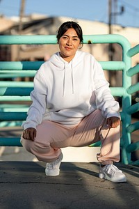 Plain white streetwear hoodie on a confident Latina woman
