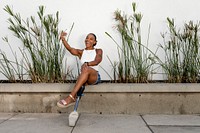 Woman taking a selfie, happy African American amputee person