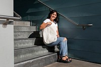 Confident Latina woman with a plain white tote bag