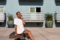 Beautiful amputee woman smiling, wearing causal clothing and listening to music