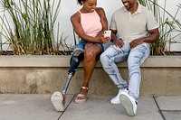 Amputee woman showing smartphone, happy couple enjoying summer