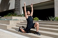 Asian man stretching outdoor in the city 