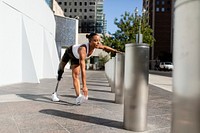 Woman with prosthetic leg stretching 