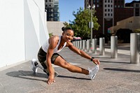 Woman with prosthetic leg stretching