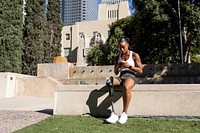 Athlete with prosthetic leg using smartphone