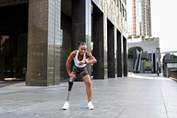 Woman with prosthetic leg looking at her smartwatch fitness tracker