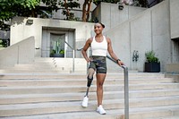 Woman with prosthetic leg walking down the stairs steps 