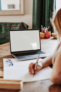 Blond girl using laptop for online class, the new normal