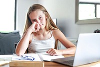 Blond girl using laptop for online class, the new normal