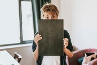 Boy holding blank black board