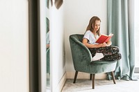 Young girl reading a book on a couch, new normal hobby