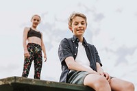 Aesthetic background, kids sitting on a roof, family photo