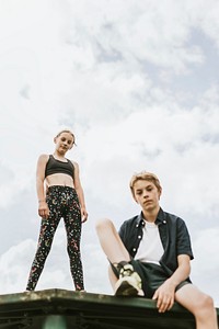 Aesthetic background, kid/kids sitting on a roof, enjoying summertime