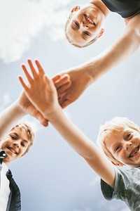 Teamwork background, kids stacking hands in the middle, family photo