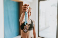 Young gymnast winner holding many medals