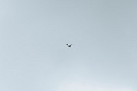 Sky background, airplane flying in the blue