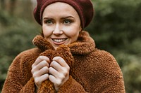 Happy woman wearing brown teddy jacket in cold autumn day