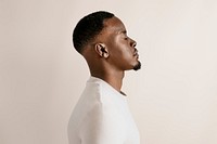 Black man in beige long sleeve, profile view psd