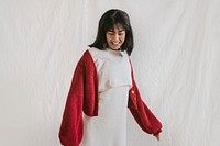 Happy woman in white dress and red cardigan, autumn apparel fashion design