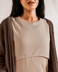 Woman wearing beige dress with brown cardigan, autumn apparel fashion design