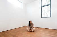 Happy woman in empty new apartment