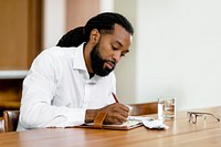 Man writing in journal in the morning