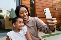 Mother taking selfie with daughter