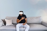 Wall mockup, man with virtual reality headset on the sofa psd