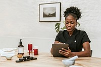 African American spa attendant using tablet for work