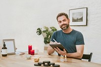 Male massage therapist holding tablet photo