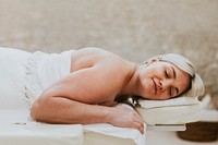 Woman getting massage in spa, health & wellness photo