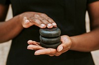 Woman holding spa stones for massage
