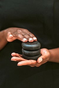Person holding spa stones for massage